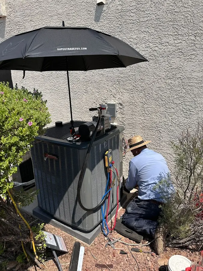 HVAC technician performing outdoor AC maintenance in Willoughby Hills