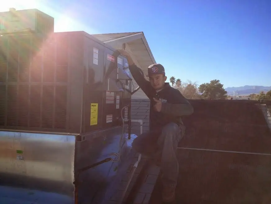 HVAC technician performing HVAC Inspection on a rooftop unit in Willoughby Hills